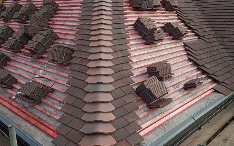 A view of roofing work being done on a building